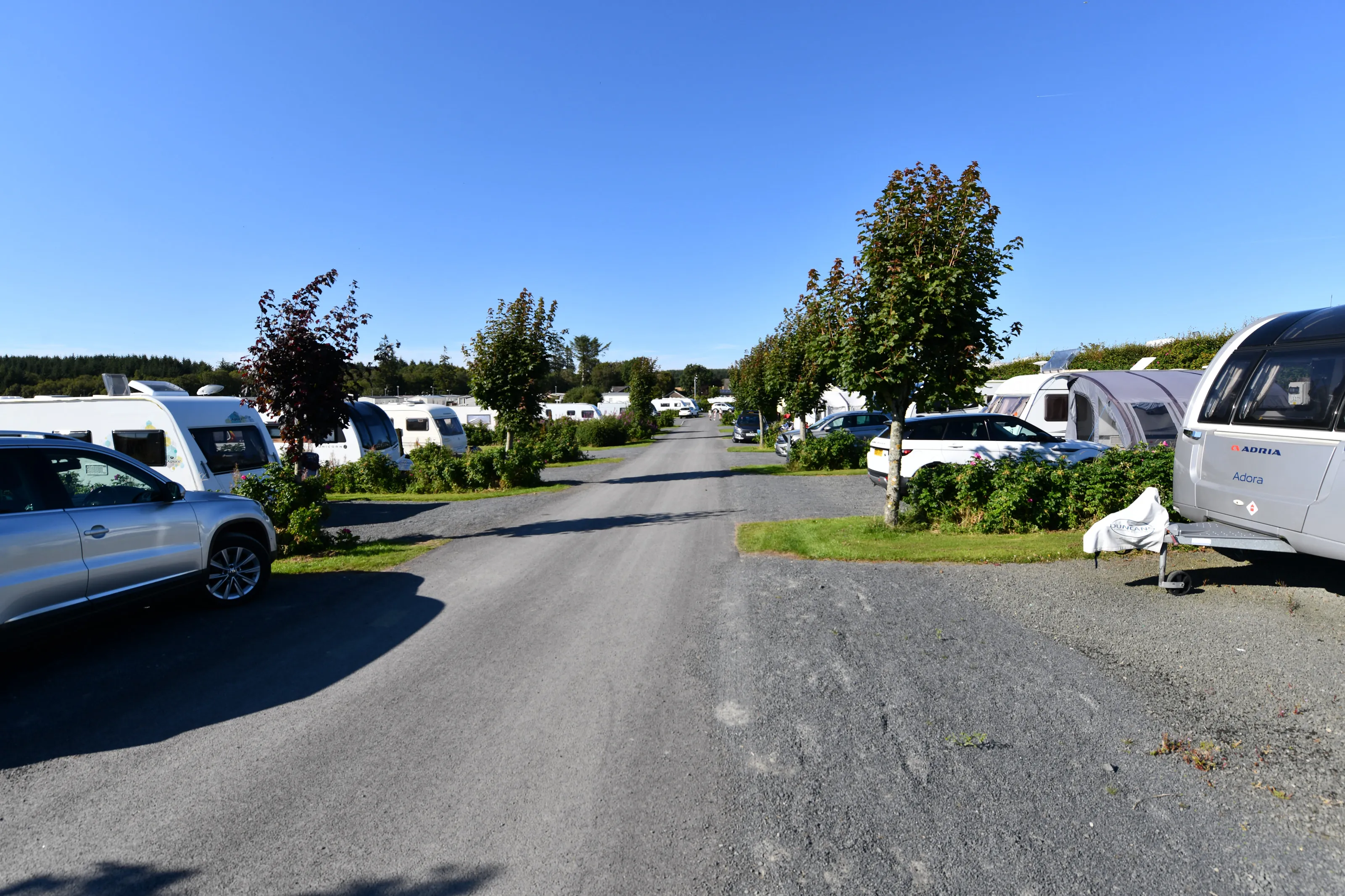 View between spacious, hard standing touring caravan pitches at The Ranch